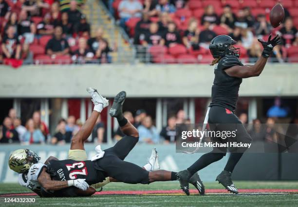 Monty Montgomery of the Louisville Cardinals reaches for the interception during the second half of the game against the Wake Forest Demon Deaconsat...