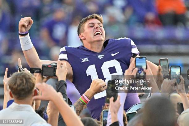 Quarterback Will Howard of the Kansas State Wildcats celebrates as he is carried across the field after beating the Oklahoma State Cowboys at Bill...