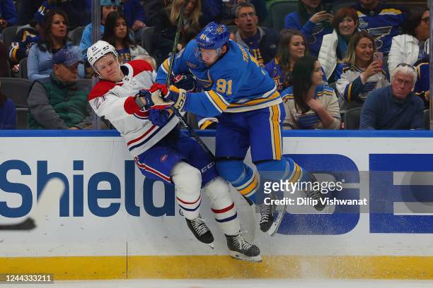 Vladimir Tarasenko of the St. Louis Blues checks Kaiden Guhle of the Montreal Canadiens during the first period of the game at Enterprise Center on...