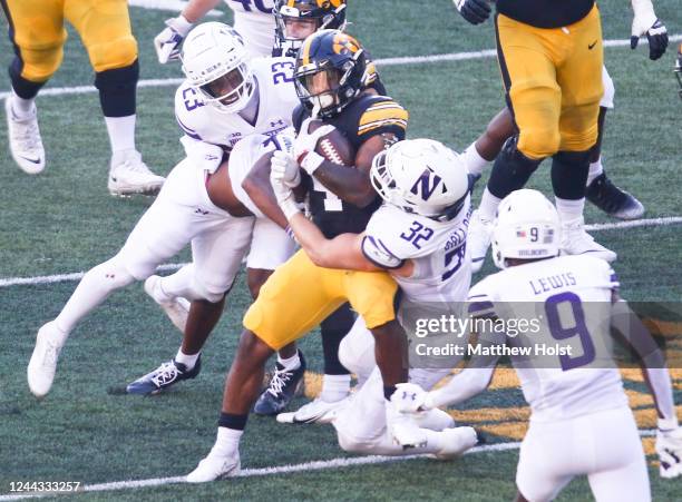 Running back Kaleb Johnson of the Iowa Hawkeyes is tackled during the first half by linebacker Bryce Gallagher of the Northwestern Wildcats at...