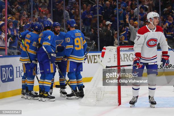 Members of the St. Louis Blues celebrate after scoring a goal against Kirby Dach of the Montreal Canadiens during the first period of the game at...