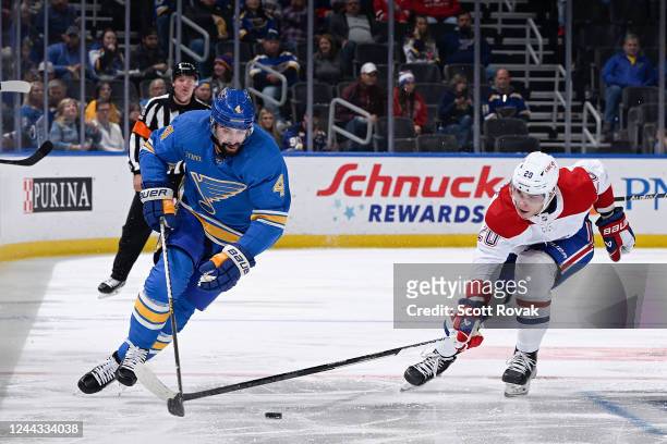 Nick Leddy of the St. Louis Blues controls the puck as Juraj Slafkovsky of the Montreal Canadiens pressures at the Enterprise Center on October 29,...