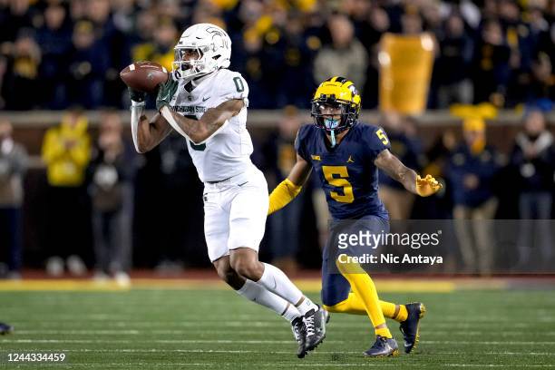 Keon Coleman of the Michigan State Spartans receives a pass against DJ Turner of the Michigan Wolverines during the second quarter at Michigan...