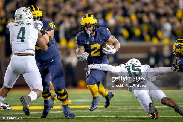 Angelo Grose of the Michigan State Spartans tackles Blake Corum of the Michigan Wolverines during the second quarter at Michigan Stadium on October...