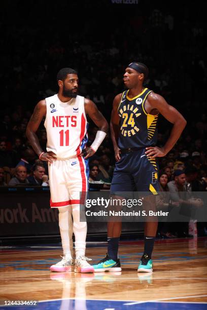 Kyrie Irving of the Brooklyn Nets talks to Buddy Hield of the Indiana Pacers during the game on October 29, 2022 at Barclays Center in Brooklyn, New...