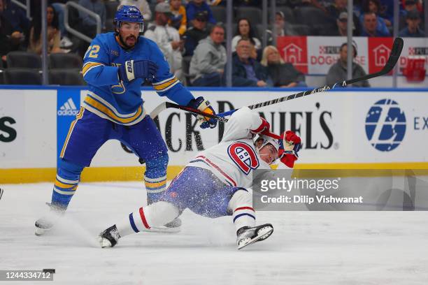 Justin Faulk of the St. Louis Blues knocks Cole Caufield of the Montreal Canadiens off the puck during the second period of the game at Enterprise...