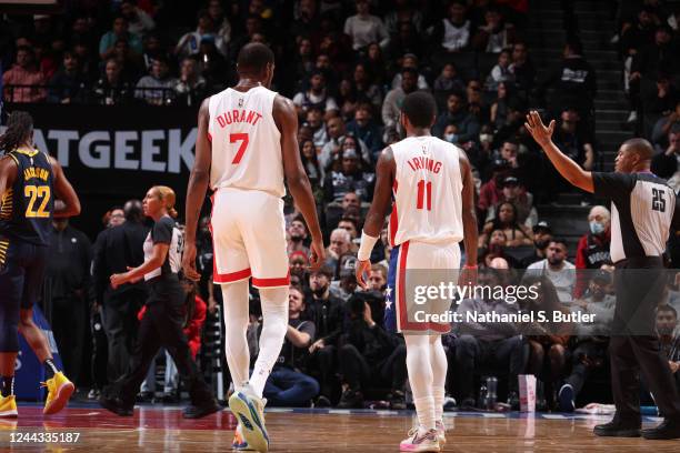 Kevin Durant and Kyrie Irving of the Brooklyn Nets look on during the game against the Indiana Pacers on October 29, 2022 at Barclays Center in...