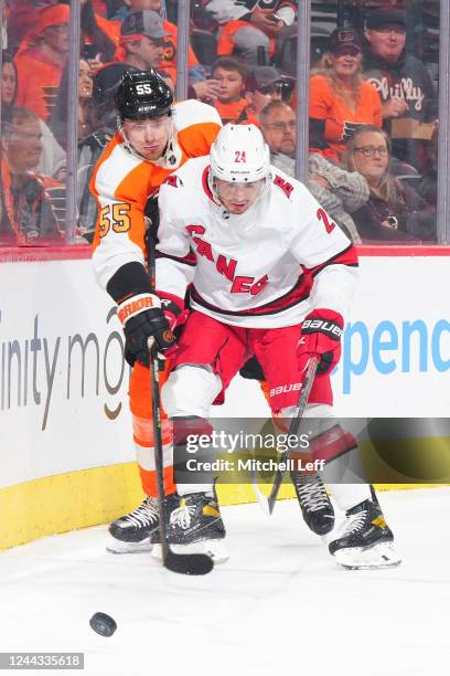 Rasmus Ristolainen of the Philadelphia Flyers battles with Seth Jarvis of the Carolina Hurricanes in the third period at the Wells Fargo Center on...