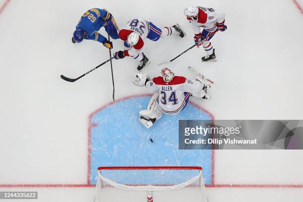 Noel Acciari of the St. Louis Blues scores a goal against Jake Allen, Christian Dvorak and Chris Wideman all of the Montreal Canadiens during the...