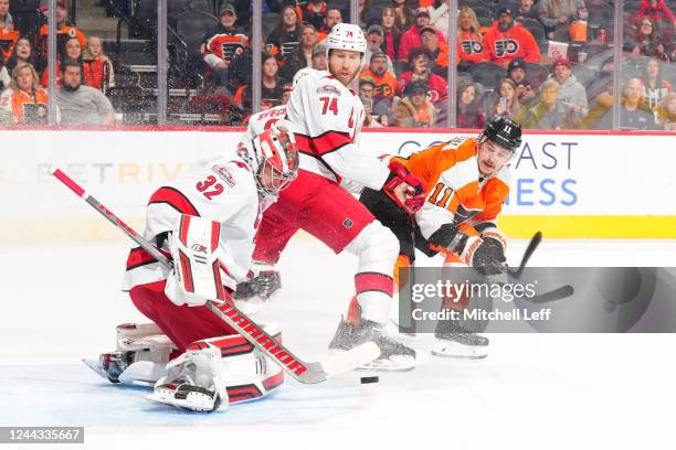 Travis Konecny of the Philadelphia Flyers shoots the puck against Jaccob Slavin and Antti Raanta of the Carolina Hurricanes in overtime at the Wells...