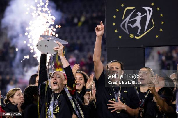 Christine Sinclair of Portland Thorns FC and Becky Sauerbrunn of Portland Thorns FC go to raise the National Womens Soccer League Championship Trophy...