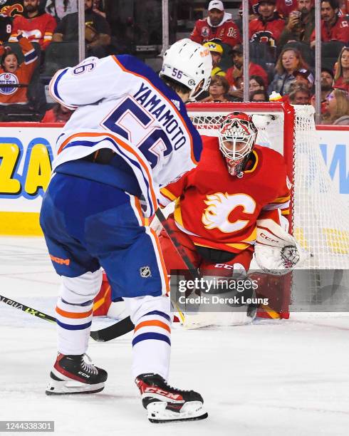 Kailer Yamamoto of the Edmonton Oilers takes a shot on Jacob Markstrom of the Calgary Flames during the second period of an NHL game at Scotiabank...