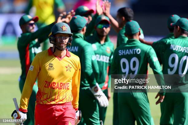 Bangadesh players celebrate the wicket of Zimbabwe's Craig Ervine as he leaves the field during the ICC men's Twenty20 World Cup 2022 cricket match...