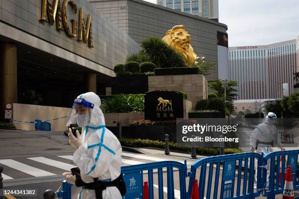 Police officers wearing personal protective guard the entrance of MGM Cotai casino resort, developed by MGM China Holdings Ltd., placed under...