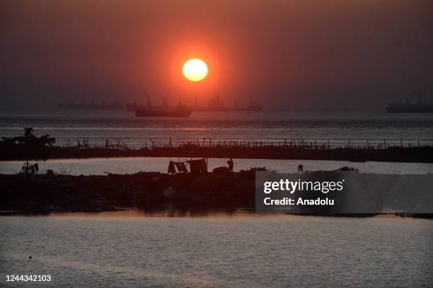 General view of the tent area set up by the people affected by Cyclone Sitrang during sunset in Patenga fishing village of Chittagong, Bangladesh on...