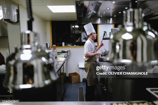 Chef cook in the Auberge Du Bois Prin during the first edition of the Casse-Croute festival in Chamonix Mont-Blanc on October 29, 2022. - The...
