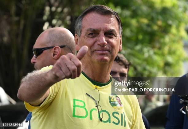 Brazilian President and re-election candidate Jair Bolsonaro gives his thumb up after voting during the presidential run-off election, in Rio de...