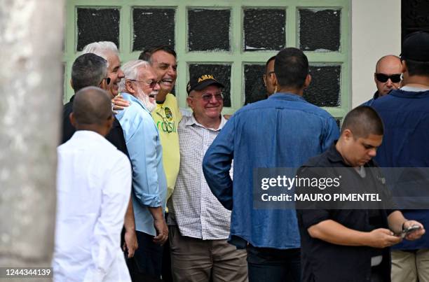 Brazilian President and re-election candidate Jair Bolsonaro poses for pictures as he arrives to vote at a polling station in Rio de Janeiro, Brazil,...