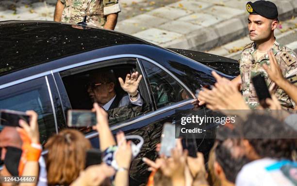 Lebanon's outgoing President Michel Aoun waves to supporters from a car as he leaves the presidential palace in Babda at the end of his mandate, east...