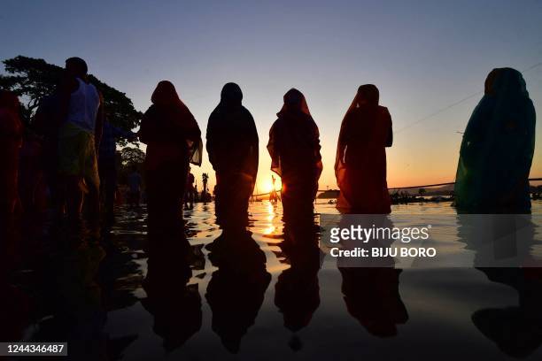 Devotees offer prayers to Sun God on the banks of river Brahmaputra on the occasion of the Hindu festival of 'Chhath Puja' in Guwahati on October 30,...