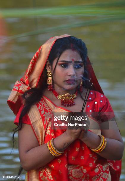 An Indian Hindu devotee holds incense sticks in his hand to offers prayers to Sun God during the Chhath Puja in Dimapur, India north eastern state of...