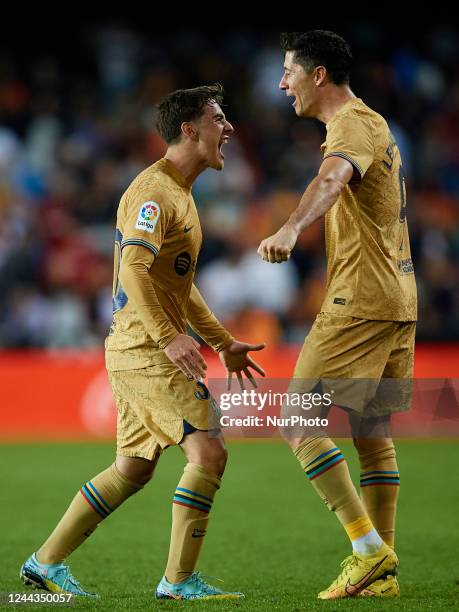 Robert Lewandowski of FC Barcelona celebrates the victory with his teammate Gavi following the LaLiga Santander match between Valencia CF and FC...