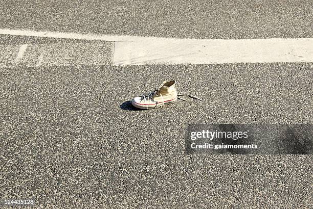 shoe on asphalt - footwear stock pictures, royalty-free photos & images