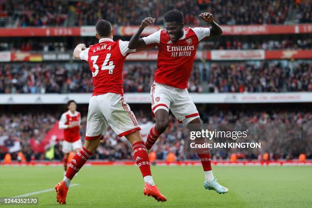 Arsenal's Ghanaian midfielder Thomas Partey celebrates with Arsenal's Swiss midfielder Granit Xhaka after scoring their fourth goal during the...
