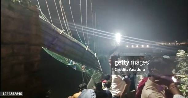View of the site after a suspension bridge collapses in Indiaâs Gujarat state on October 30, 2022. Hundreds plunged into river after the bridge...