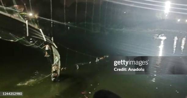 View of the site after a suspension bridge collapses in Indiaâs Gujarat state on October 30, 2022. Hundreds plunged into river after the bridge...