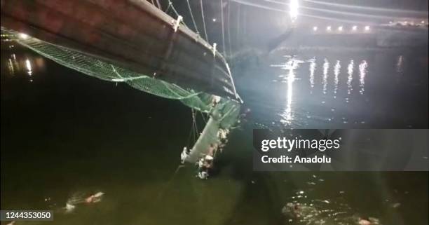 View of the site after a suspension bridge collapses in Indiaâs Gujarat state on October 30, 2022. Hundreds plunged into river after the bridge...