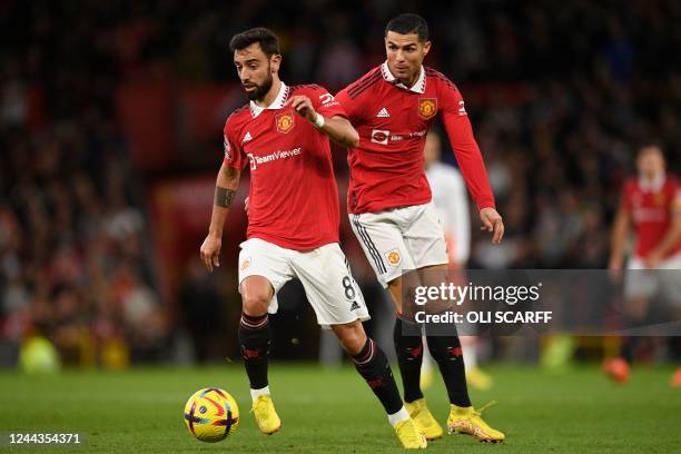 Manchester United's Portuguese striker Cristiano Ronaldo looks on as Manchester United's Portuguese midfielder Bruno Fernandes looks to play a pass...