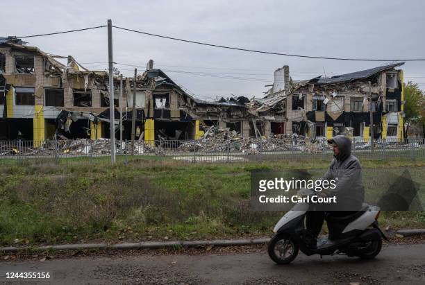 Man passes a school that was destroyed by a Russian missile, on October 30, 2022 in Apostolove, Dnipropetrovsk oblast, Ukraine. Russia has said it's...