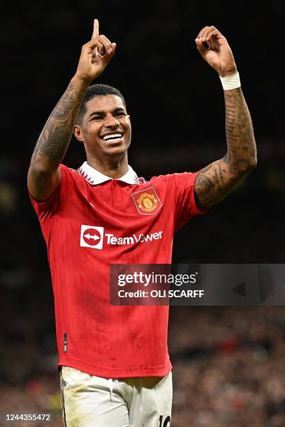 Manchester United's English striker Marcus Rashford indicates it's his 100th Man Utd goal as he celebrates scoring the opening goal of the English...