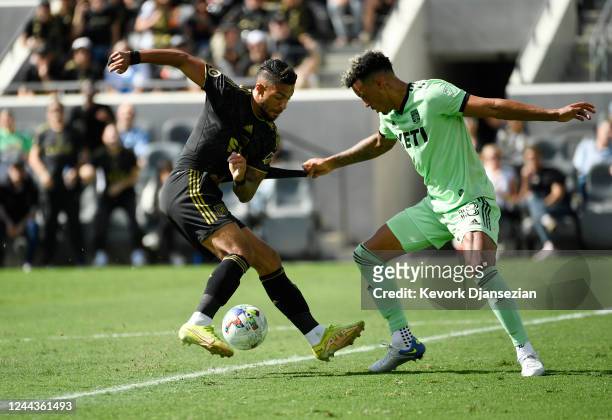 Julio Cascante of Austin FC pulls on the shirt of Denis Bouanga of Los Angeles FC during the first half of the Western Conference Finals of the 2022...