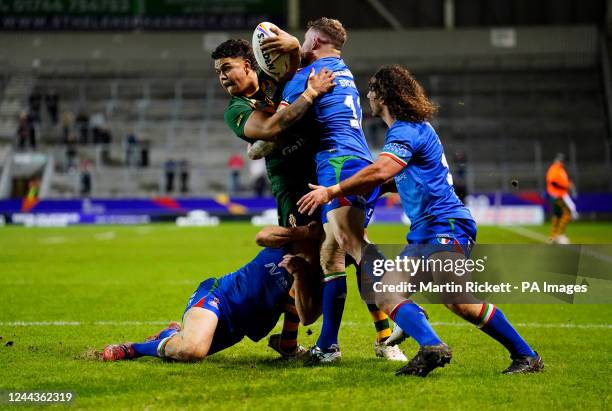 Australia's Latrell Mitchell is tackled by Italy's Nathan Brown during the Rugby League World Cup group B match at the Totally Wicked Stadium, St...