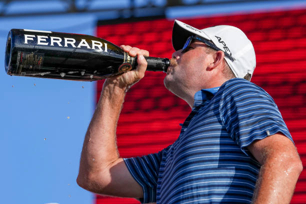 Marc Leishman of Punch GC drinks champagne on the podium after the team championship stroke-play round of the LIV Golf Invitational - Miami at Trump...