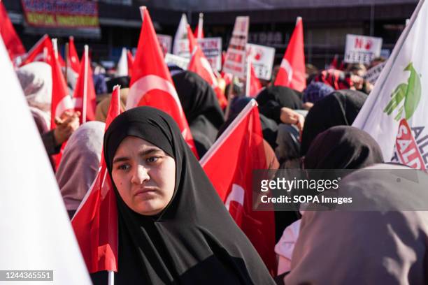 Women wearing hijabs hold Turkish flags during the demonstration. An anti-LGBTI march and press release took place in Ankara, Turkey which is planned...