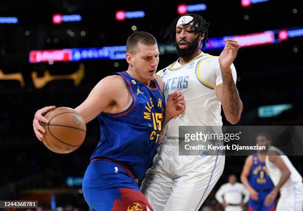 Nikola Jokic of the Denver Nuggets pushes against Anthony Davis of the Los Angeles Lakers during the first half at Crypto.com Arena on October 30,...