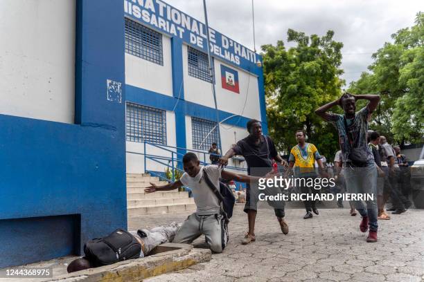Graphic content / TOPSHOT - Journalists cry and call for help near the body of Romelo Vilsaint, who was hit by a teargas canister as they gathered at...