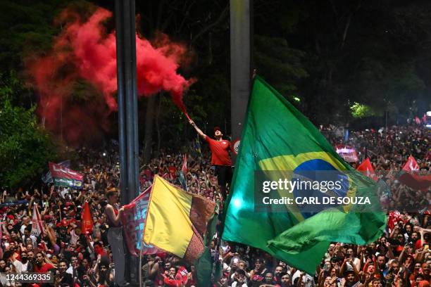 Supporters of president-elect Luiz Inacio Lula da Silva celebrate while listening to his speech at the Paulista avenue after his victory on the...