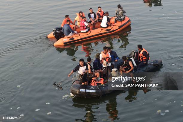 Rescue personnel conduct search operations after a bridge across the river Machchhu collapsed at Morbi in India's Gujarat state on October 31, 2022....