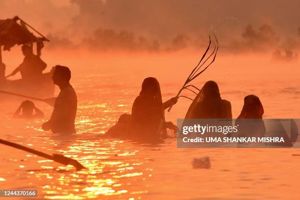 Devotees gather on the banks of river Narmada to worship the sun during the Hindu festival of Chhath Puja in Jabalpur on October 31, 2022.