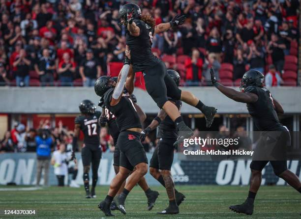 Ashton Gillotte of the Louisville Cardinals celebrates with Momo Sanogo of the Louisville Cardinals after a fumble recovery against the Wake Forest...