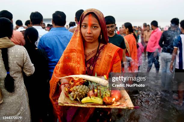 Hindu devotee performs religious ritual into the Arabian Sea on the day of Chhath Puja festival in Mumbai, India, 31 October, 2022. The Chhath...