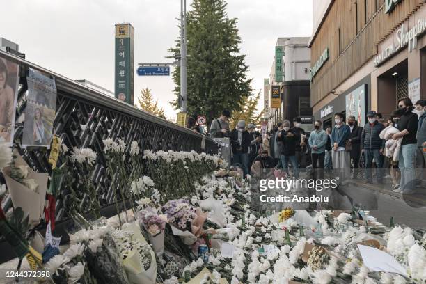 Flowers are seen at a makeshift memorial outside a subway station in the district of Itaewon in Seoul on October 31 two days after a deadly Halloween...