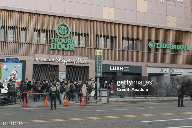 People gather outside a subway station in the district of Itaewon in Seoul on October 31 two days after a deadly Halloween crowd crush. At least 154...