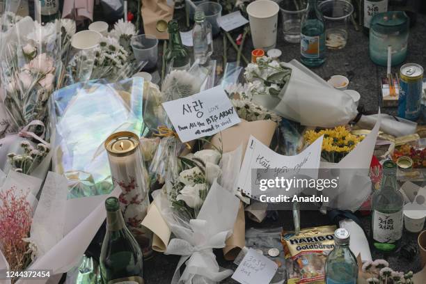 Flowers are seen at a makeshift memorial outside a subway station in the district of Itaewon in Seoul on October 31 two days after a deadly Halloween...