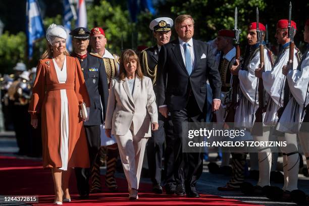 King Willem-Alexander and Queen Maxima of the Netherlands flanked by Greek President Katerina Sakellaropoulou review the presidential guard during...