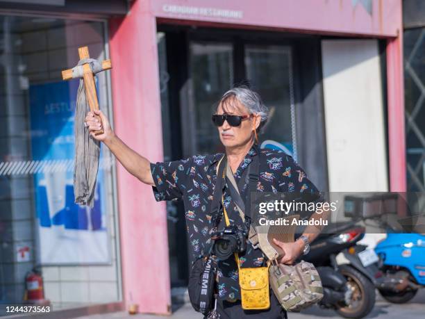 Man is seen with wooden cross at a makeshift memorial outside a subway station in the district of Itaewon in Seoul on October 31 two days after a...